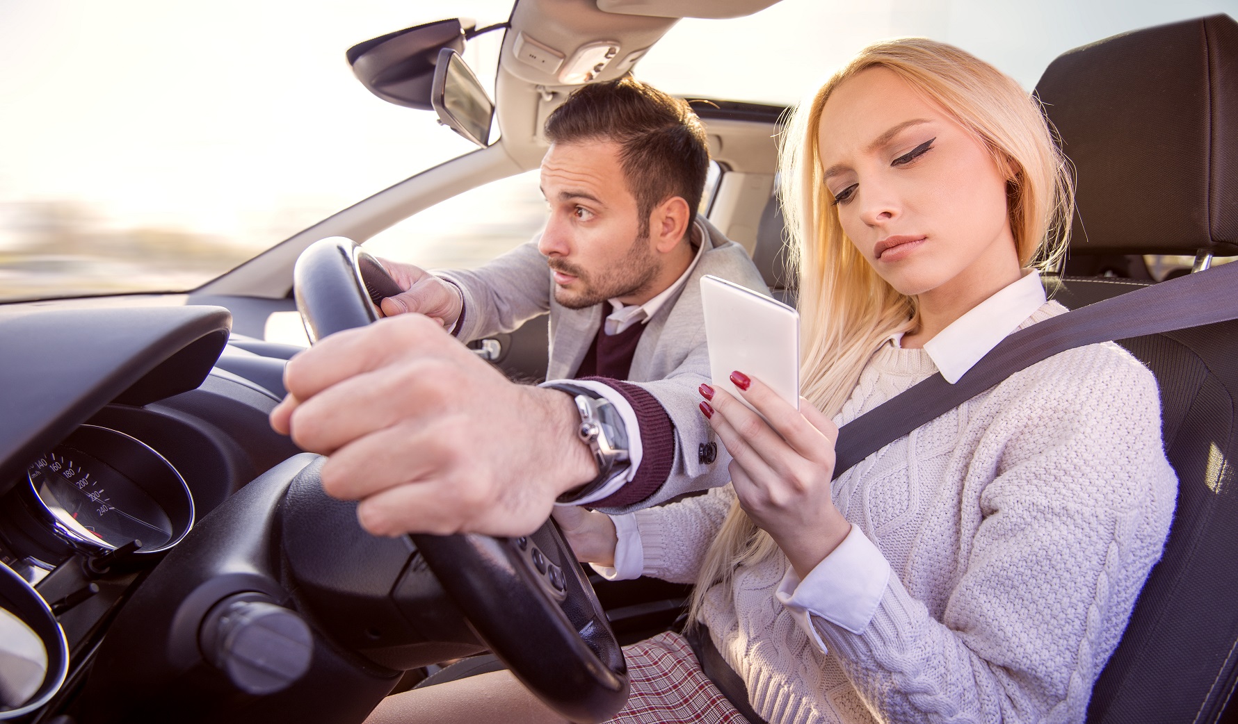Woman typing text message while driving a car