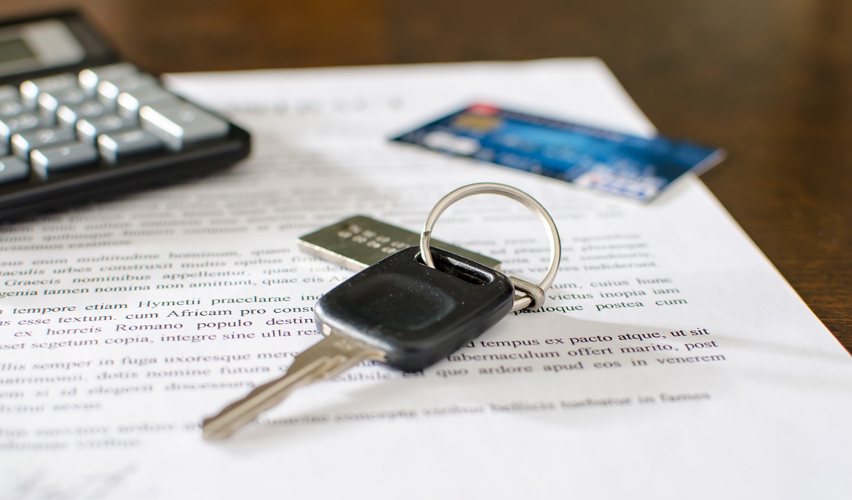 Car key, credit card on a signed sales contract
