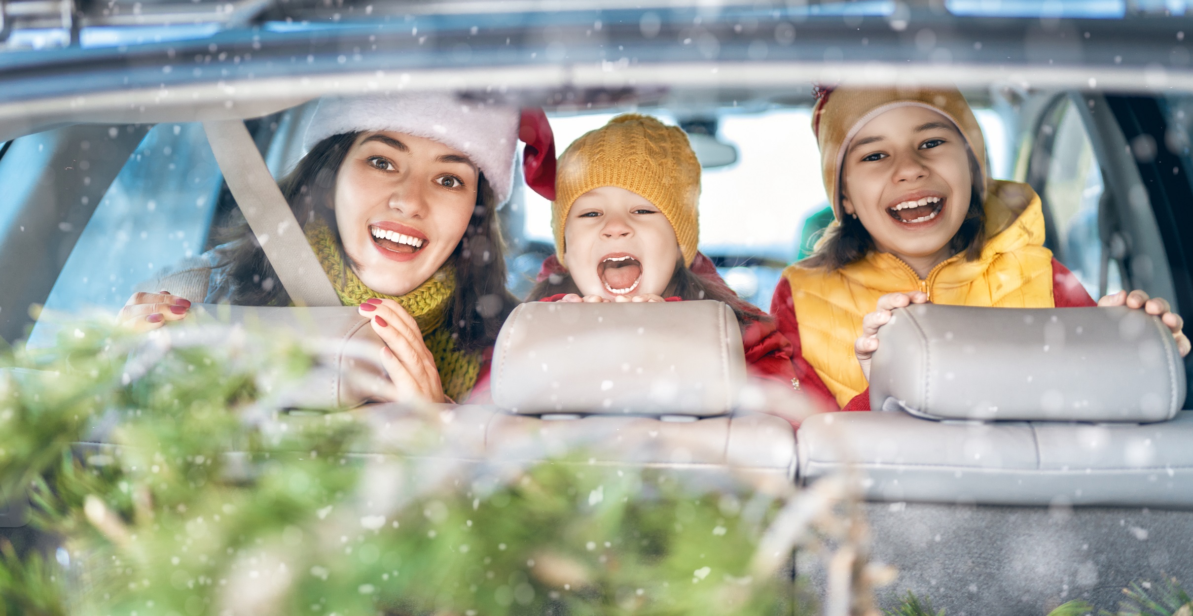 Mother, children and car on snowy winter nature